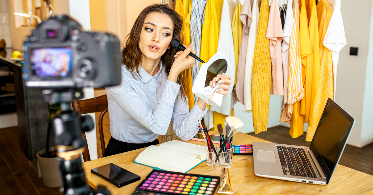 woman applying make-up in front of a camera