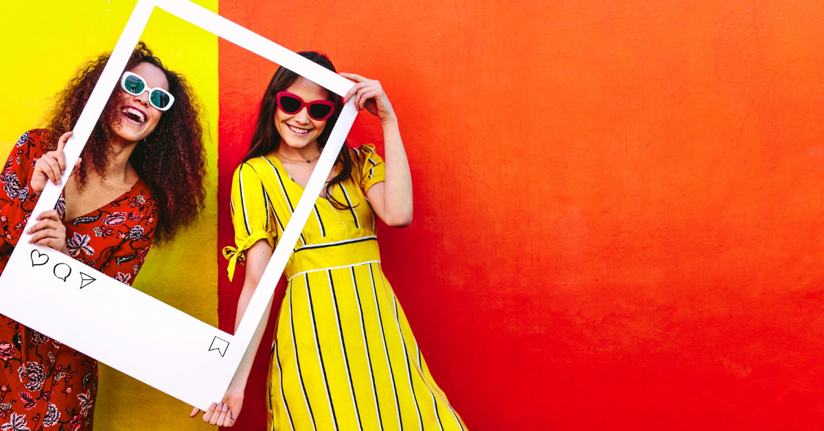 Two girls behind a 3D Instagram photo frame