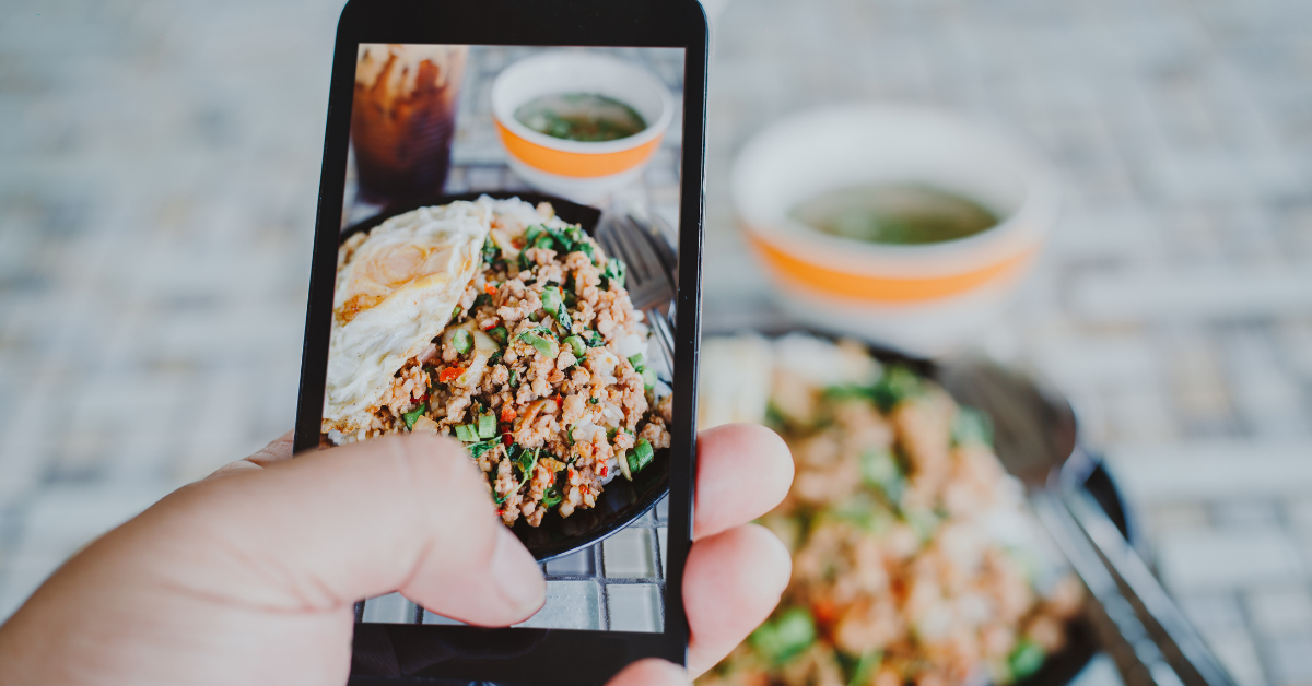 A person taking a picture of a dish