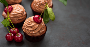 Chocolate cupcakes with cherries on top