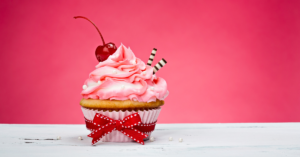 Pink cupcake with cherry on top