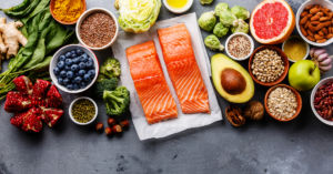 a table full of healthy food such as salmon and avocado