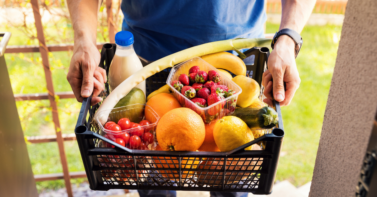 man holding a basket of produce
